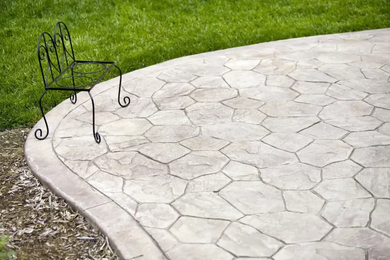 Decorative stamped concrete patio in Jenks with fire pit